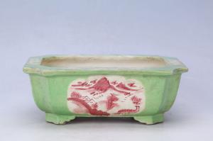 002823绿釉开光山水纹四足花盆